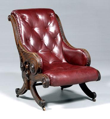 Carved walnut library chair, rolled