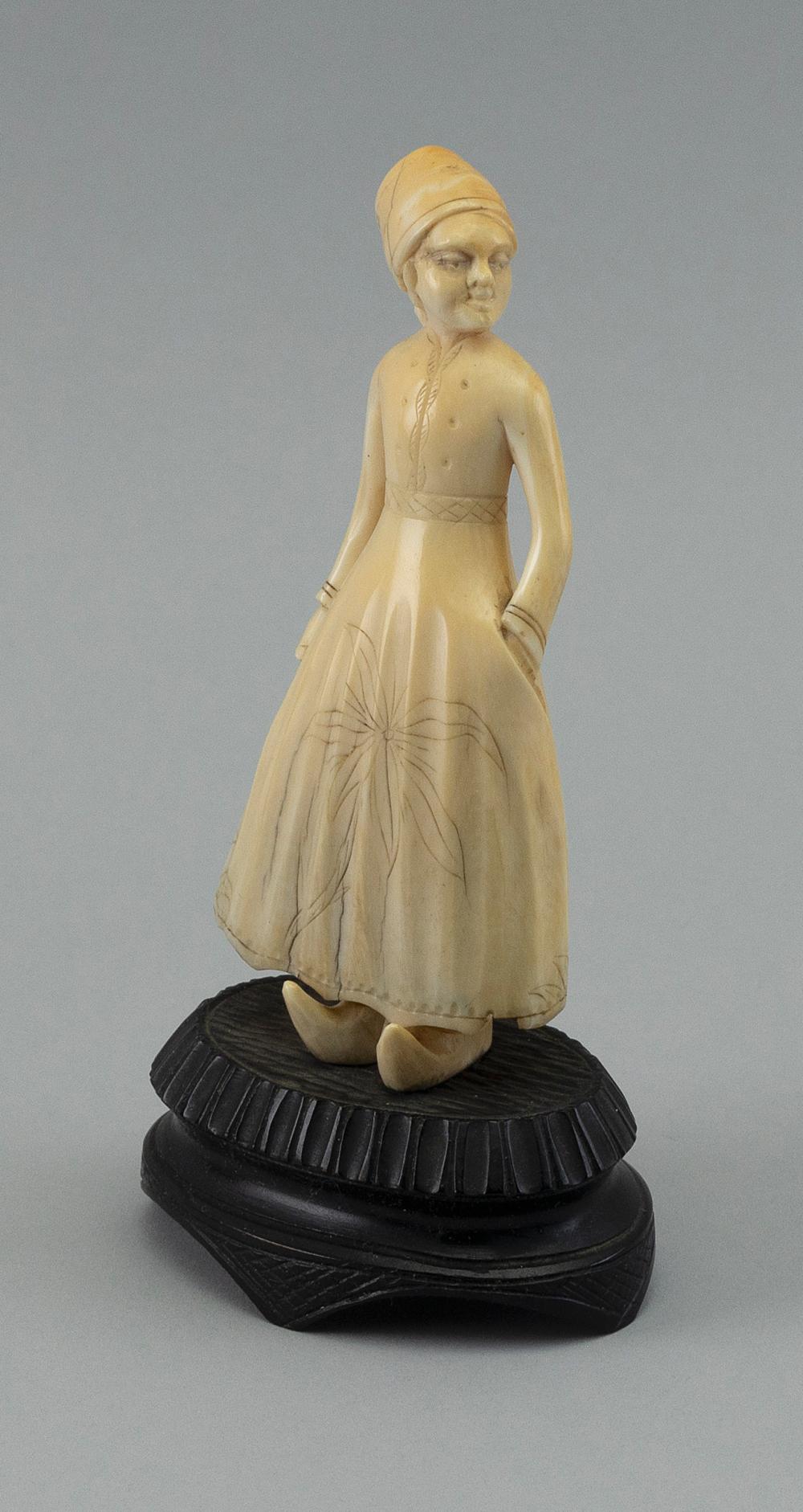 CARVED WHALE IVORY FIGURE OF A