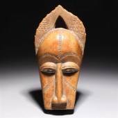 Carved wood African mask with