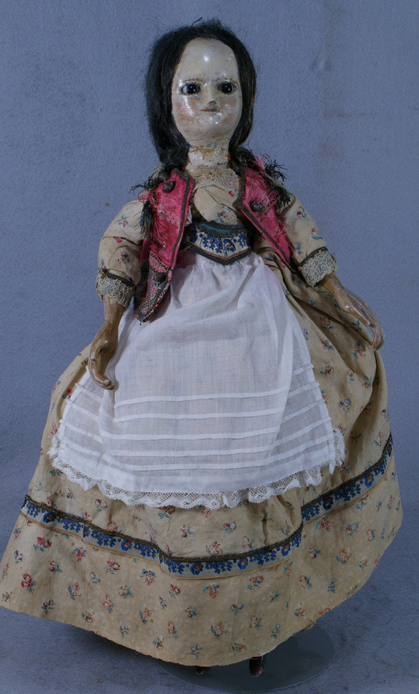 Carved wood doll with pinned