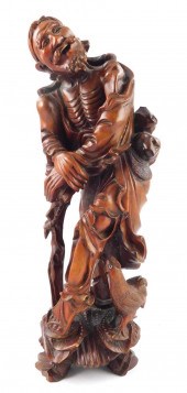 CARVED WOOD FIGURE OF AN IMMOR