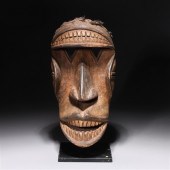 Carved wooden African mask wit