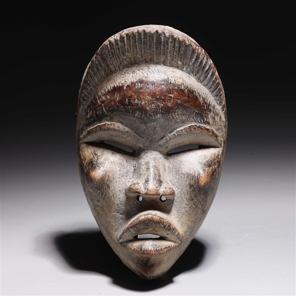 Carved wooden mask in the style