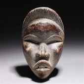 Carved wooden mask in the styl