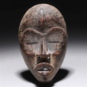 Carved wooden mask in the styl