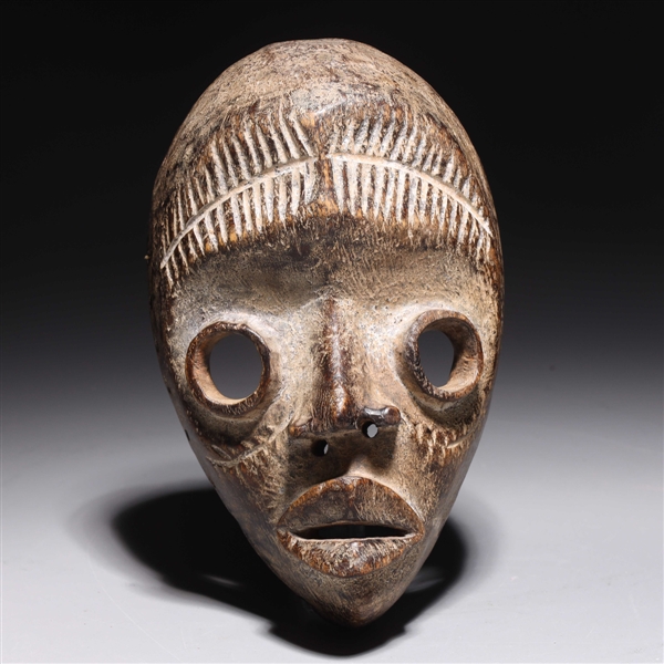 Carved wooden mask in the style