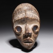 Carved wooden mask in the styl