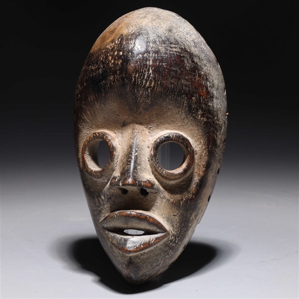 Carved wooden mask in the style