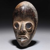 Carved wooden mask in the styl