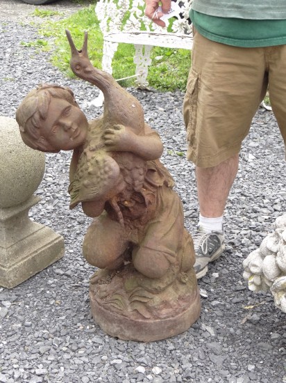 Cast iron boy and goose fountain.