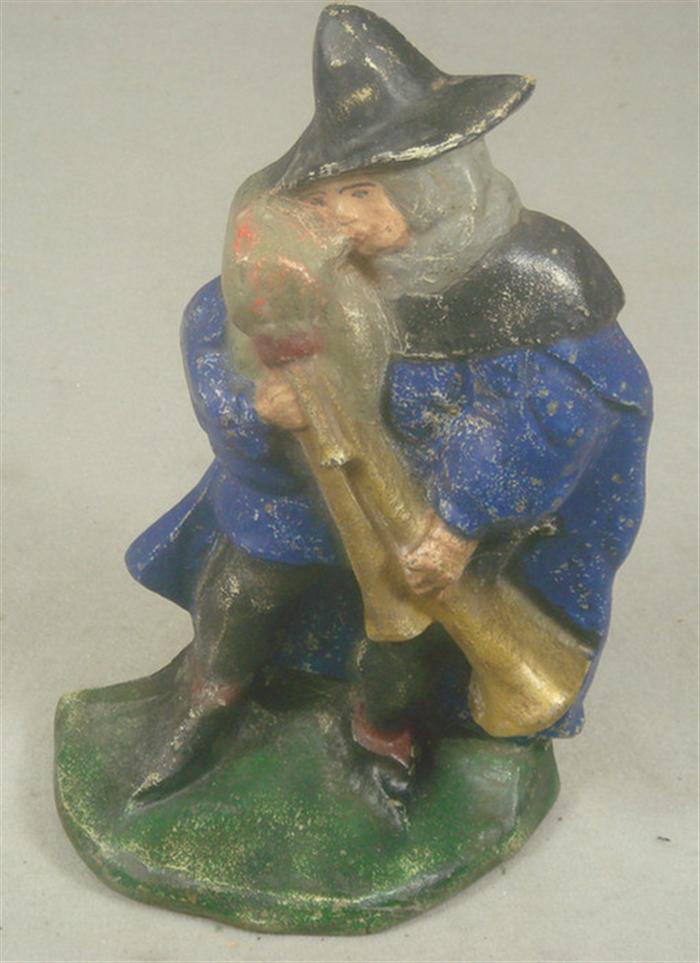 Cast iron doorstop, man playing