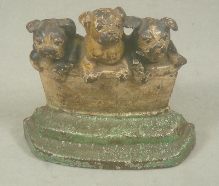 Cast iron doorstop, three puppies