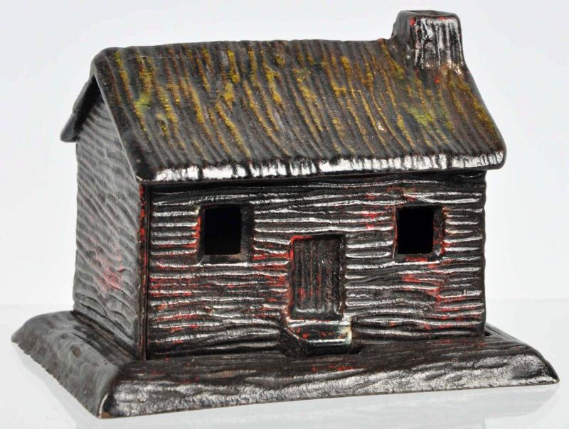 Cast Iron Log Cabin Still Bank. 