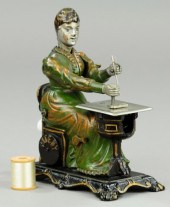 CAST IRON WOMAN AT SEWING MACH