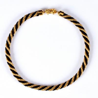Celine, a black and gold twisted