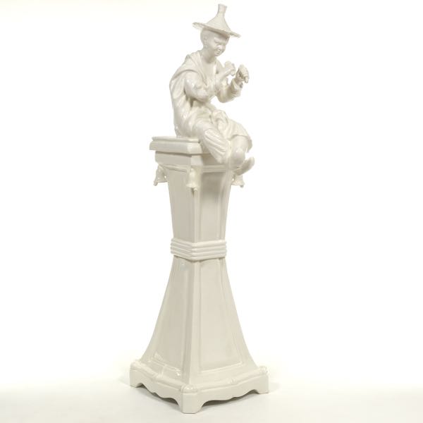 CERAMIC SCULPTURE OF A BOY ON A