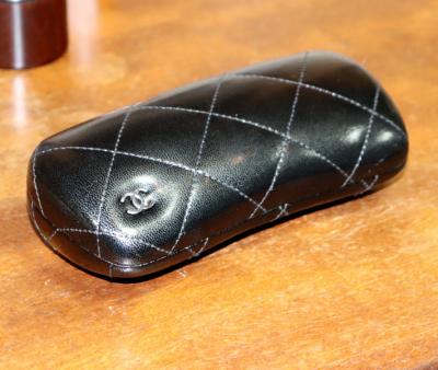 Chanel, a black quilted patent
