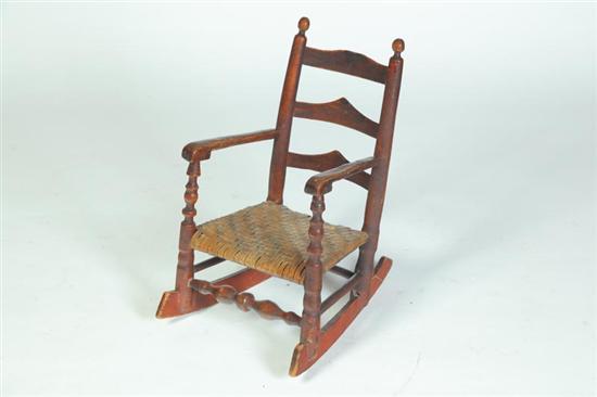 CHILD'S LADDERBACK ARMCHAIR ROCKER.
