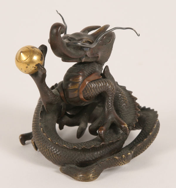 Chinese bronze dragon clasping a