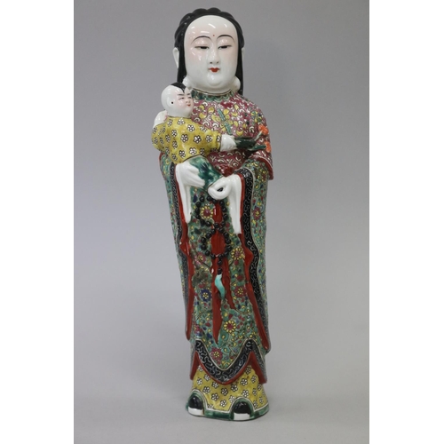 Chinese woman carrying a small