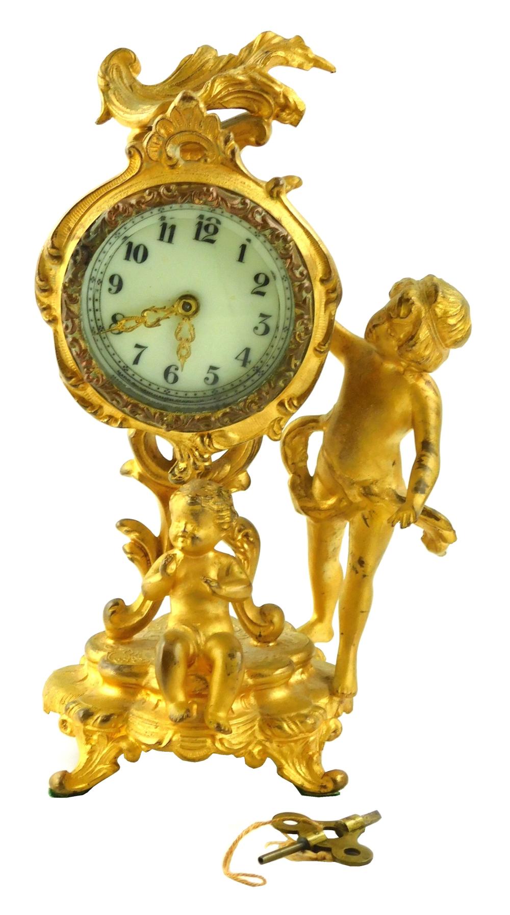 CLOCK: FIGURAL GILT MANTEL CLOCK BY