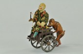 CLOWN ON CART PUSHED BY MONKEY