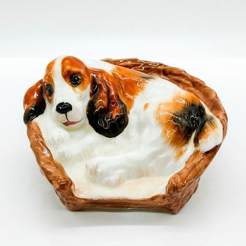 COCKER SPANIEL LYING IN BASKET -