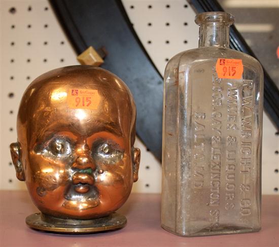 Copper and brass baby's head and an