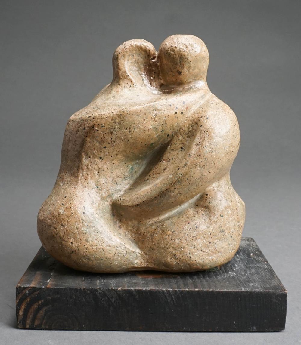 COUPLE EMBRACING CARVED STONE