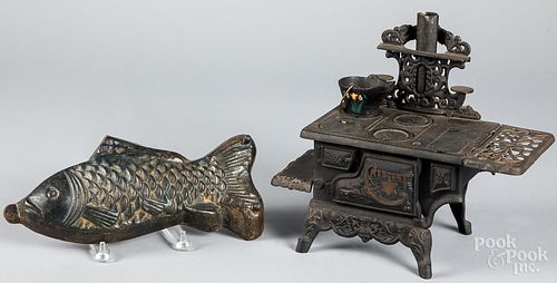CRESCENT DOLL STOVE AND A CAST FISH