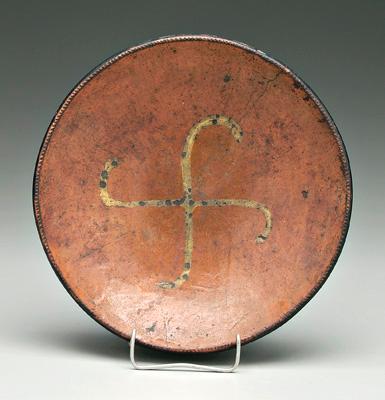 Decorated redware bowl, fylfot slip