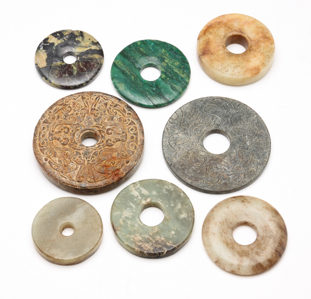 EIGHT ASIAN STONE DISKS.