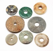 EIGHT ASIAN STONE DISKS. Twent
