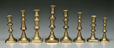 Eight brass candlesticks: all