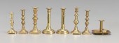 Eight brass candlesticks: one