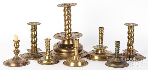EIGHT EMBOSSED AND ENGRAVED BRASS