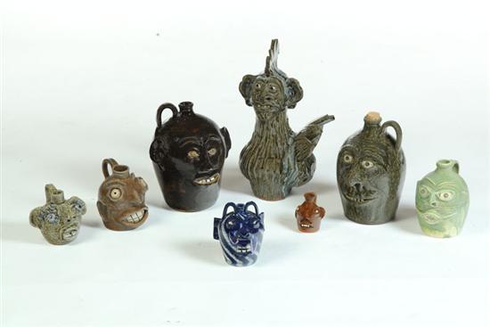 EIGHT GROTESQUE FACE JUGS. 