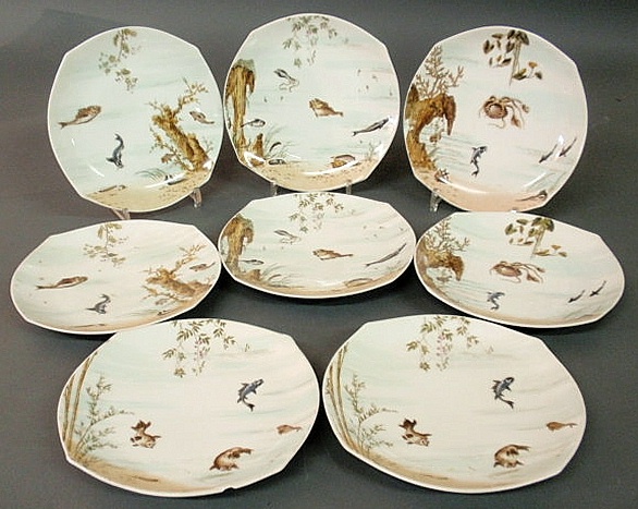Eight Limoges fish plates of