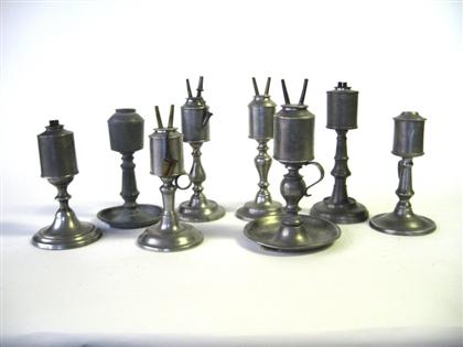Eight pewter cylinder fonted lamps