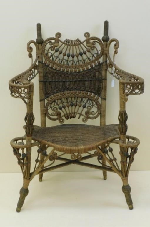 ELABORATE WICKER ARM CHAIR BY AN