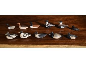 Eleven painted wood, stone and