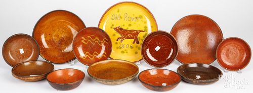 ELEVEN REDWARE PLATES AND SHALLOW