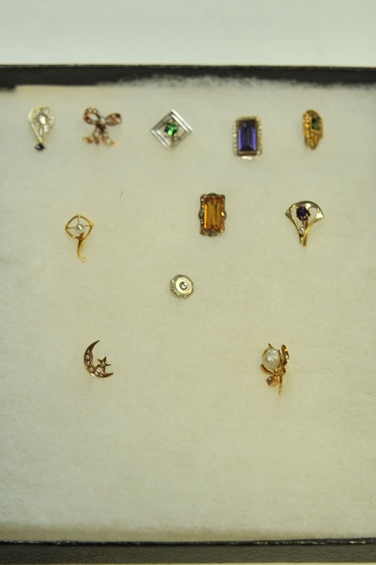 ELEVEN STICK PINS. One with