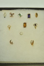 ELEVEN STICK PINS. One with il