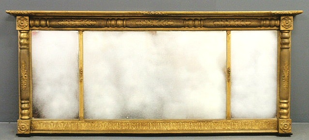 Empire gilt overmantel mirror.