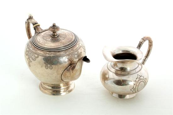 ENGRAVED SILVER TEAPOT AND CREAMER.