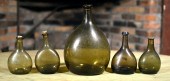 FIVE 19TH C. CHESTNUT BOTTLES.