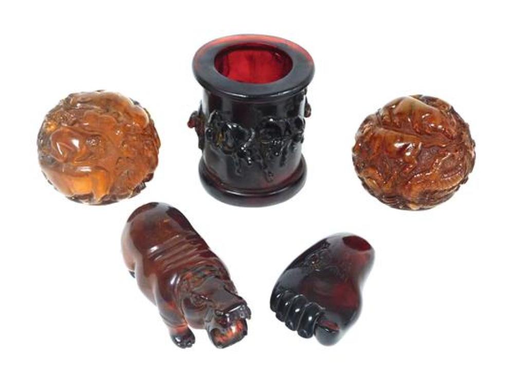 FIVE CARVED AMBER-TYPE PIECES,