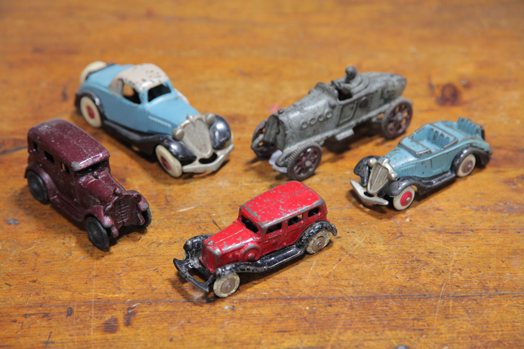 FIVE CAST IRON AUTOMOBILES. 