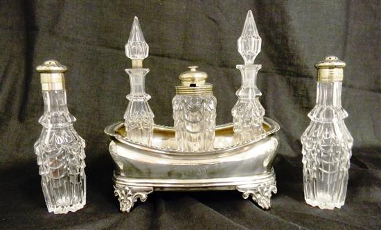 Five cut glass cruet bottles on